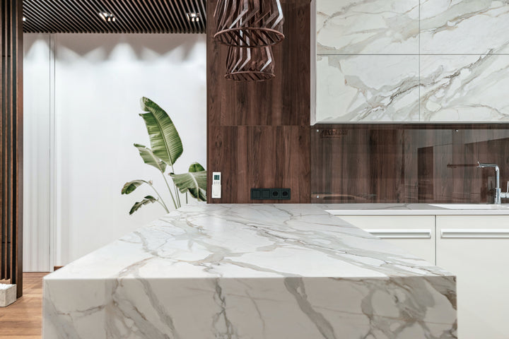 Dekton Optimma Morpheus on a kitchen island with a timber-panelled wall