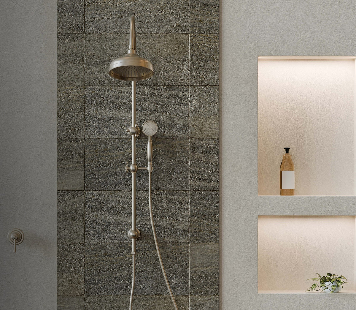 Phoenix Cromford twin shower in brushed nickel against a stone feature wall with lit shower niches