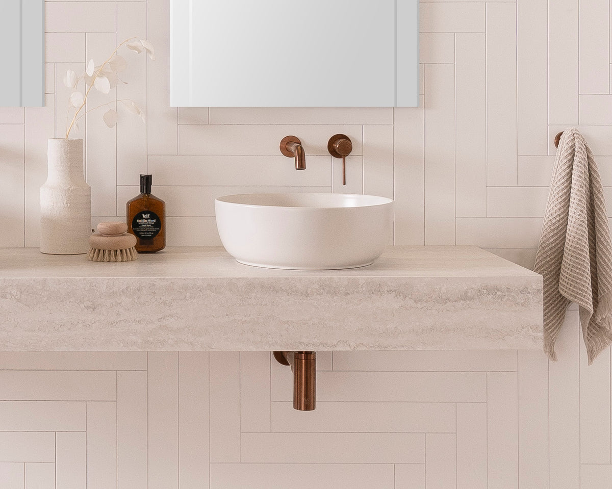 Michel Wall Hung Vanity - Michel 1800 Wall Hung. 150mm mitred benchtop in Grey Travertine Cherry Pie. Glam Round Above-Counter Basins and Soul Tapware in Brushed Copper